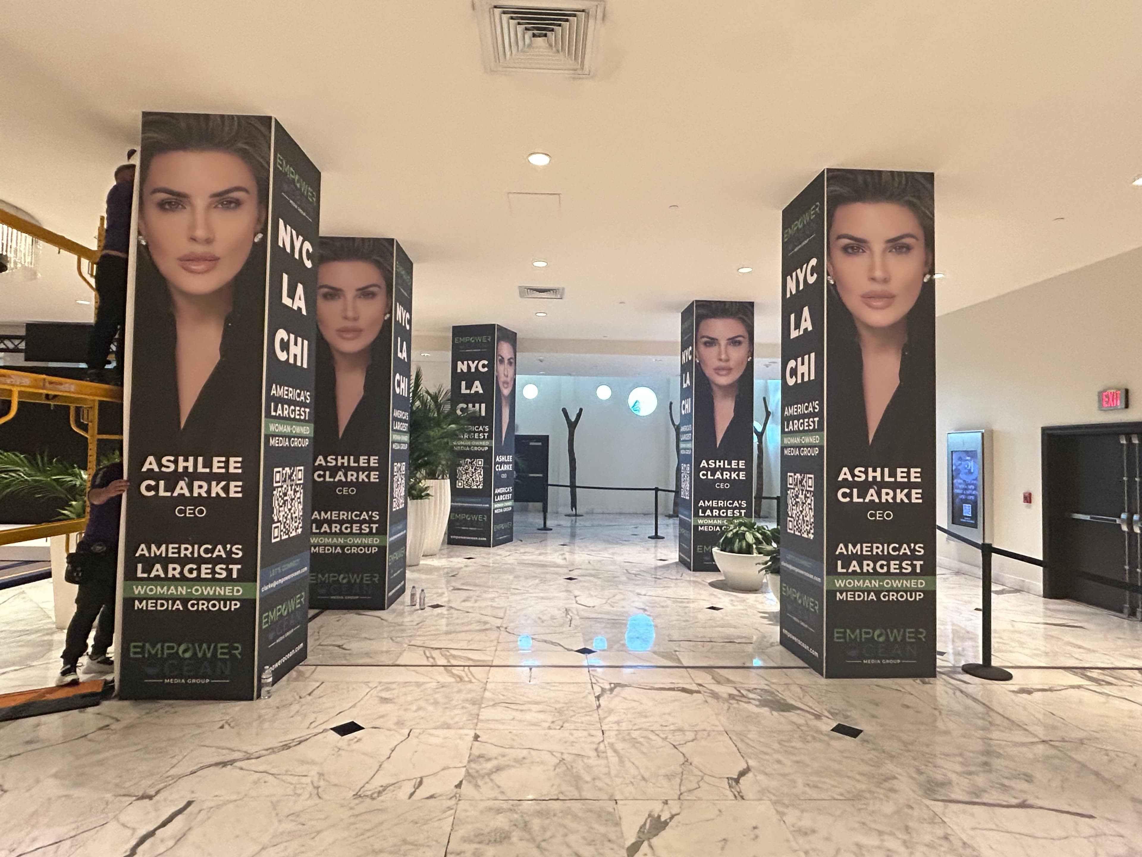 Coordinated promotional graphics covering multiple columns in a commercial interior